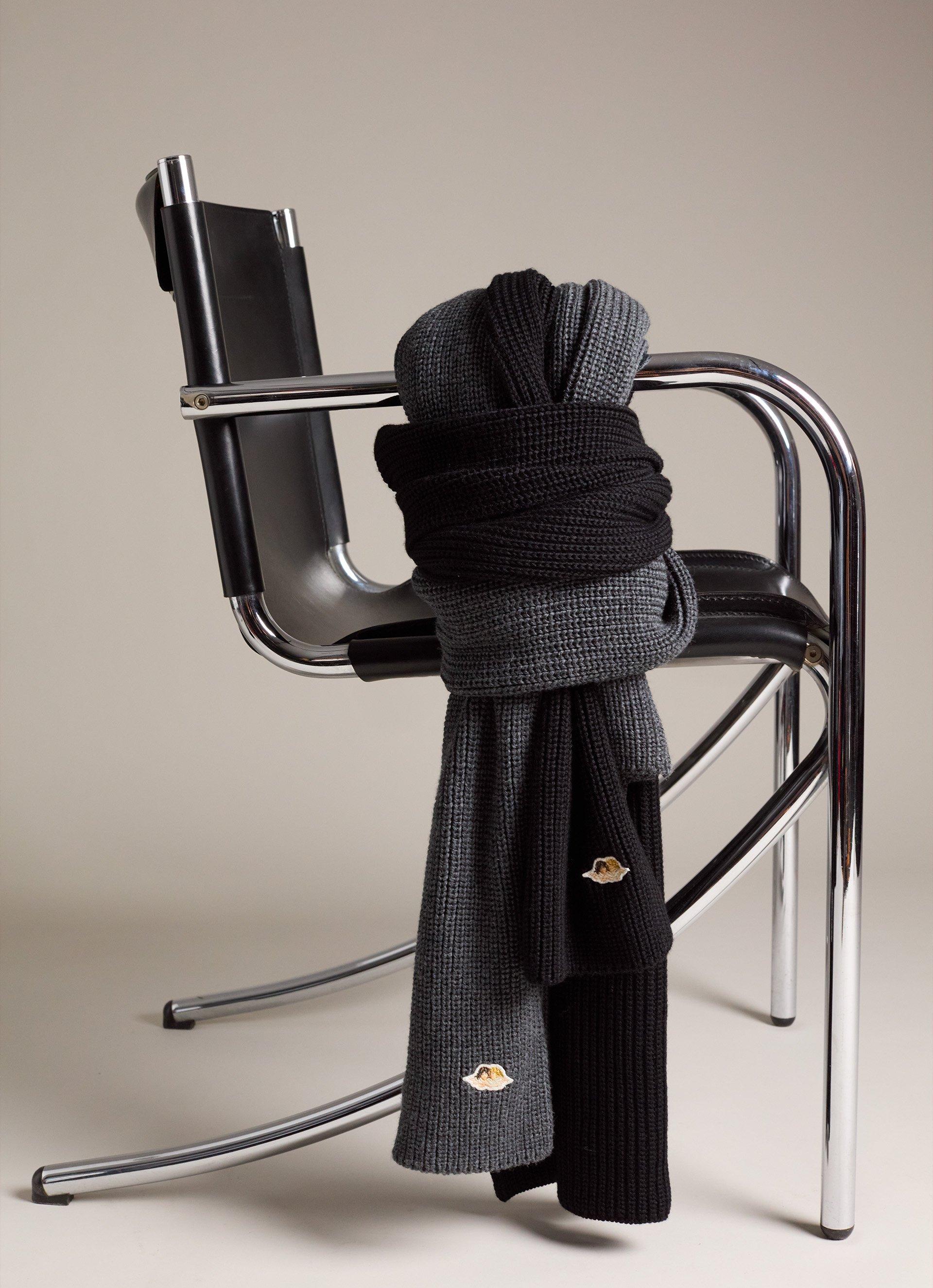 The picture features the Angels Patch Scarf in Grey and the the Angels Patch Scarf in Black.